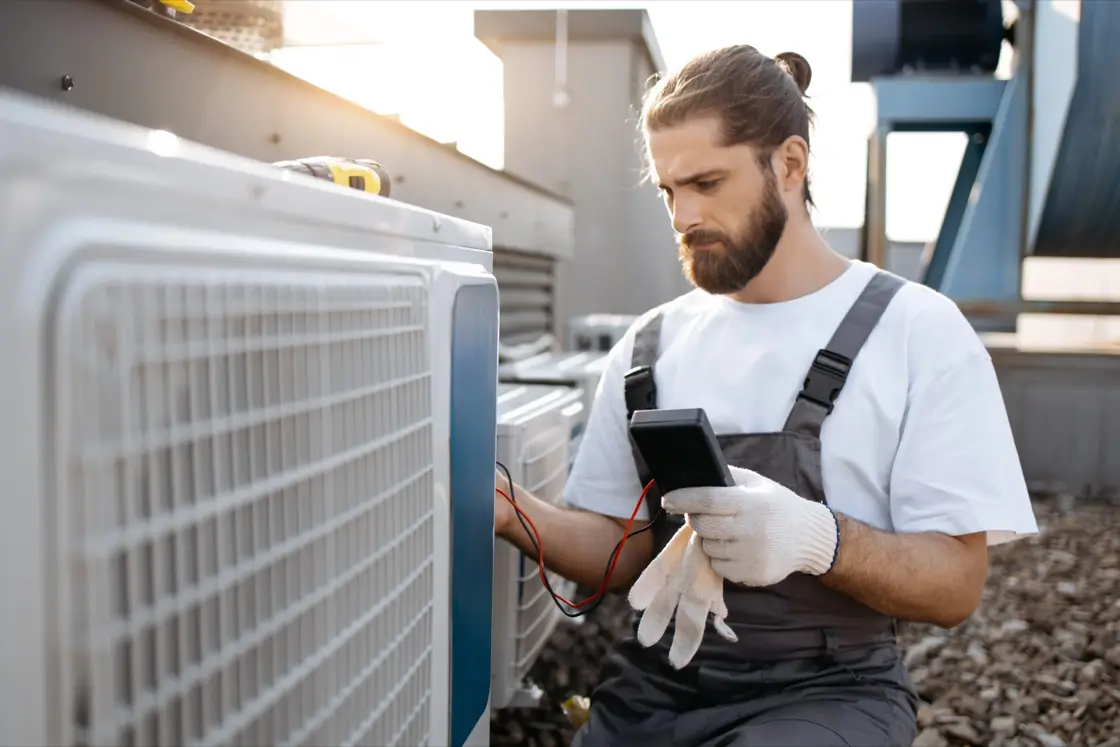 HVAC engineer diagnosing a heating system with a multimeter in Naperville, IL